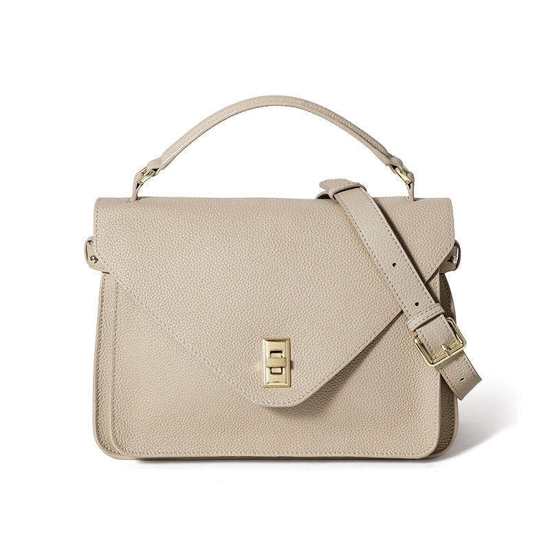 Beige handbag with a gold clasp on a white background
