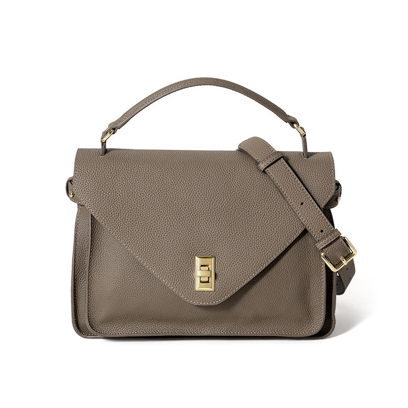 Brown leather satchel bag with a gold clasp on a white background