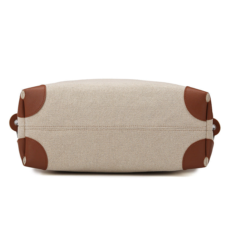 Beige toiletry bag with brown accents on a white background