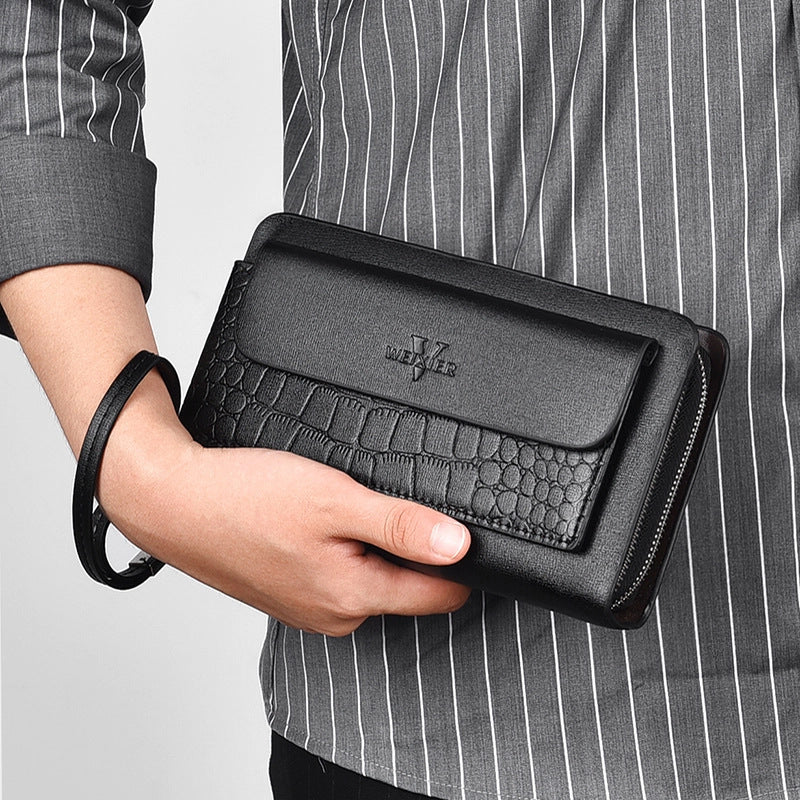 Person holding a black leather wallet with a textured finish