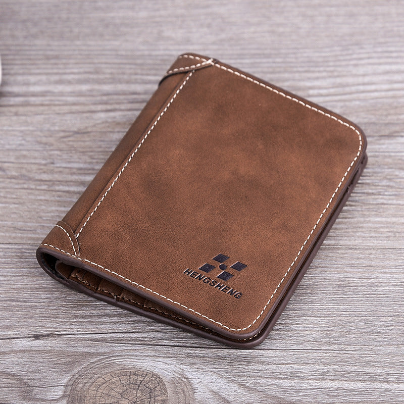 Brown leather wallet with visible brand logo on a wooden surface