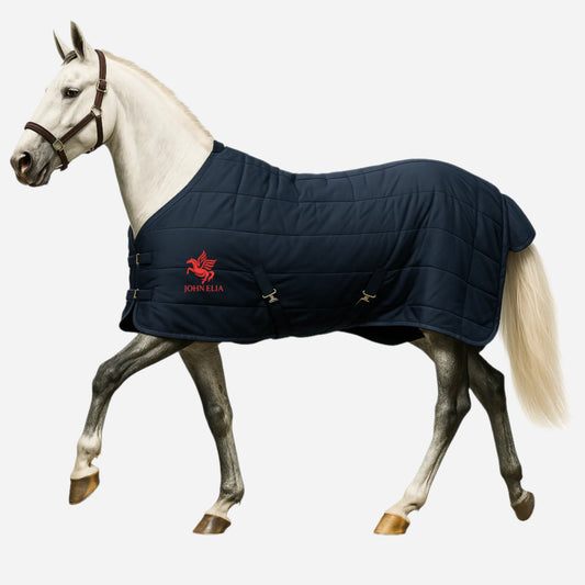 Horse wearing a navy blue quilted blanket with a visible brand logo on a white background