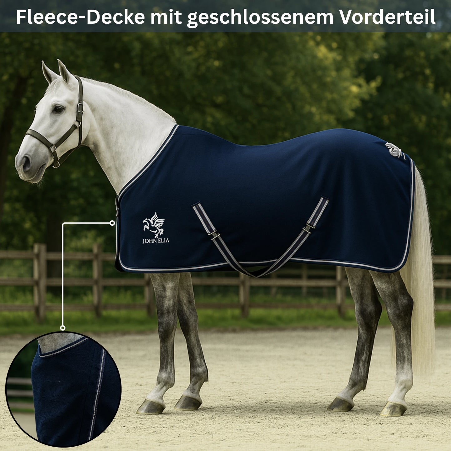 Horse wearing a navy blue fleece blanket with a brand logo, standing on a sandy surface with greenery in the background.